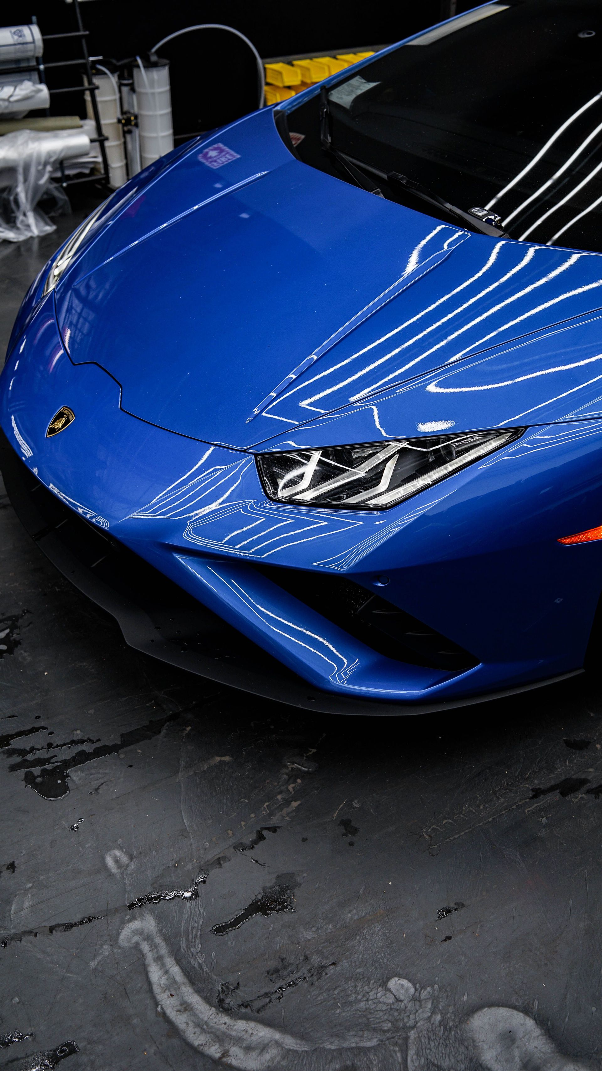 Eye-catching blue Lamborghini Aventador parked in a garage showcasing its sleek design and vibrant color.